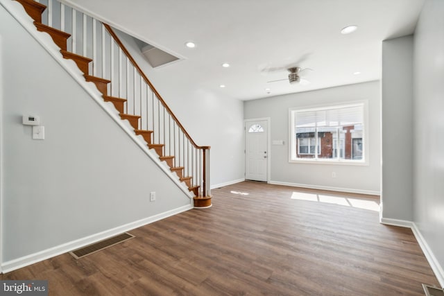 foyer with ceiling fan and dark hardwood / wood-style flooring