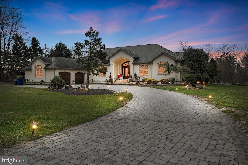 view of front of house with a lawn and a garage