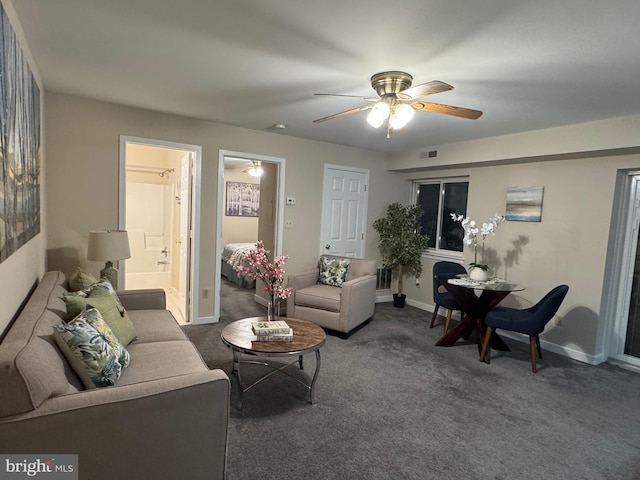 living room with carpet, visible vents, ceiling fan, and baseboards