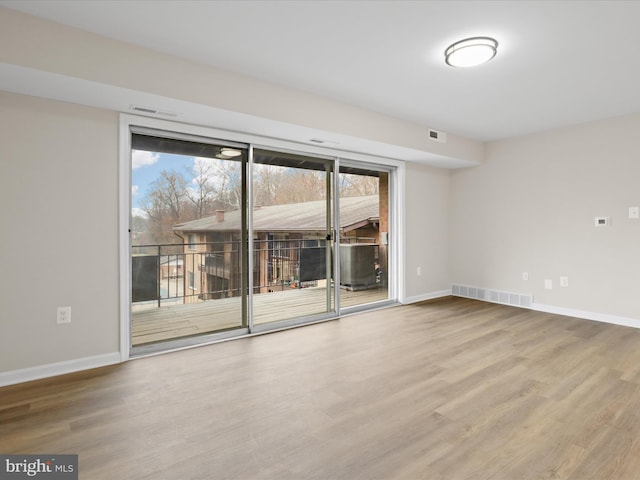 unfurnished room with hardwood / wood-style floors