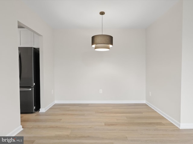 unfurnished dining area with light wood-type flooring