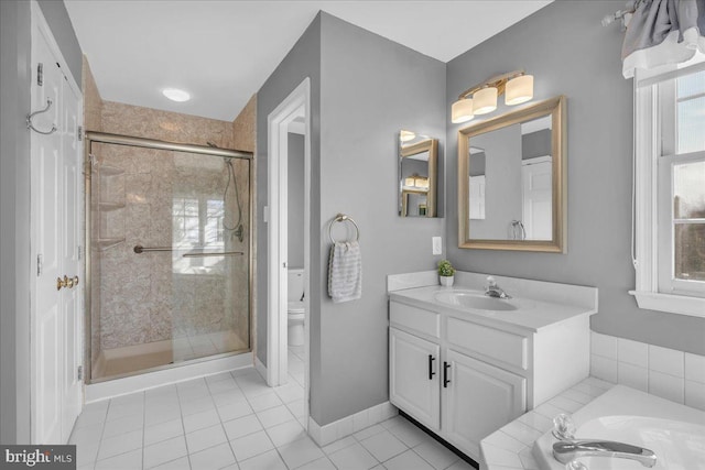 full bathroom with a wealth of natural light, vanity, and independent shower and bath