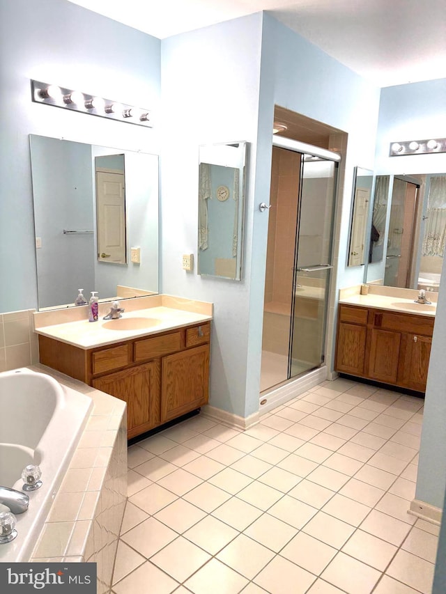 bathroom featuring vanity, tile patterned flooring, and plus walk in shower