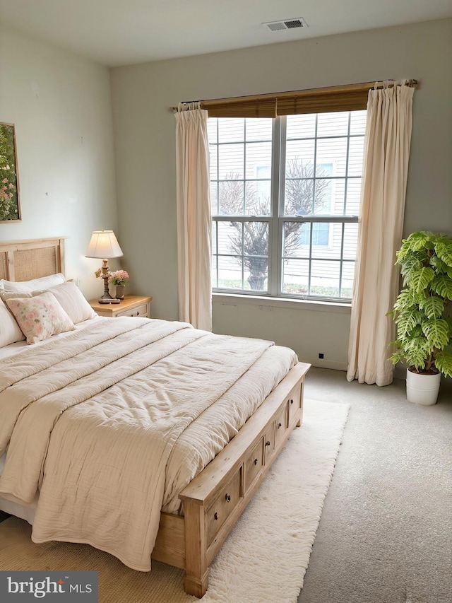 bedroom featuring light colored carpet