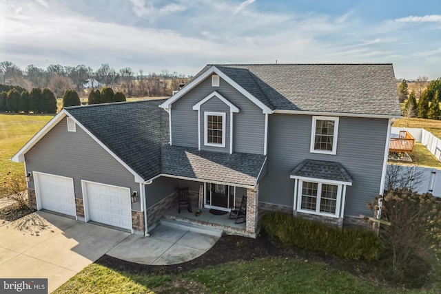 view of property featuring covered porch and a garage