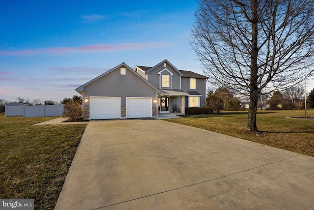 front facade featuring a garage and a yard