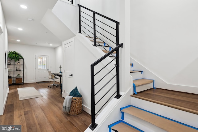 staircase featuring hardwood / wood-style flooring