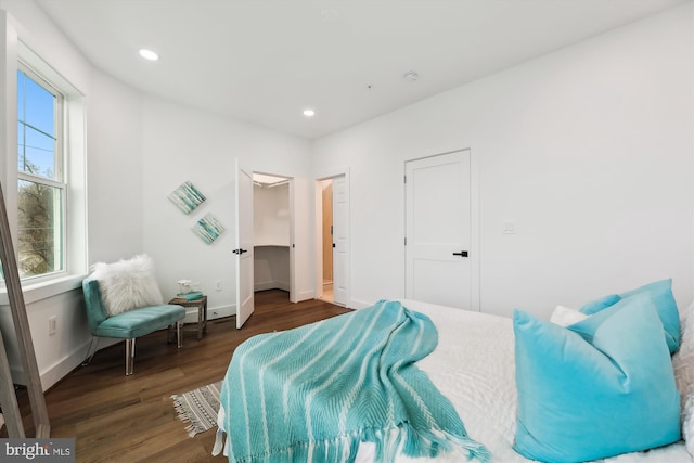 bedroom with dark hardwood / wood-style floors