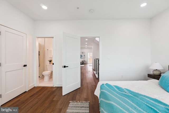 bedroom with dark hardwood / wood-style flooring and connected bathroom