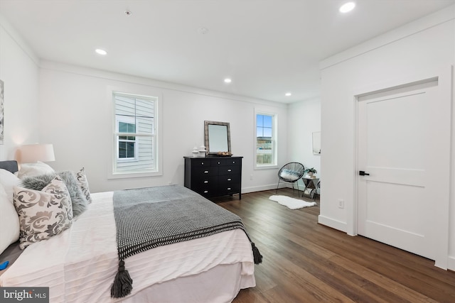 bedroom featuring dark wood-type flooring and ornamental molding