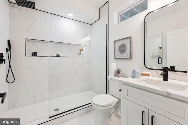 bathroom with vanity, toilet, and walk in shower