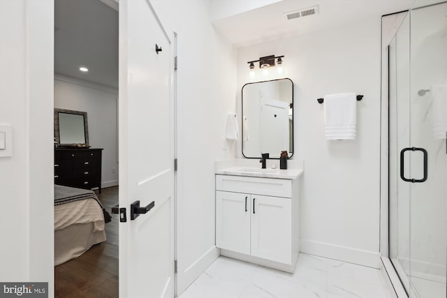 bathroom with a shower with door and vanity