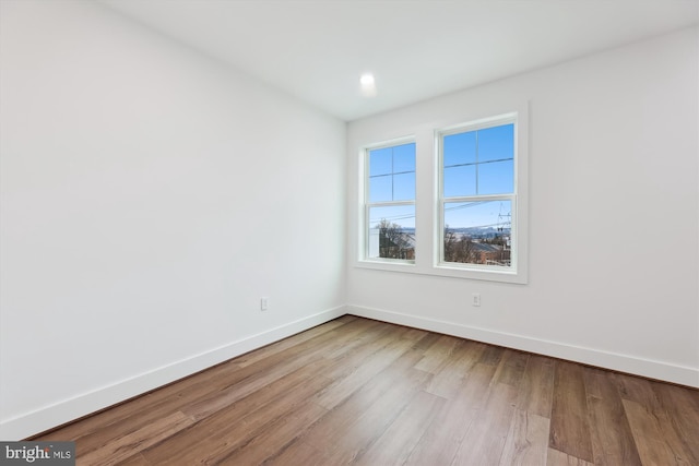 unfurnished room with light wood-type flooring