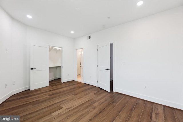 unfurnished bedroom featuring dark hardwood / wood-style flooring