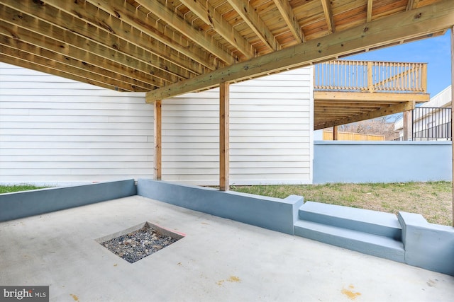 view of patio / terrace with a fire pit and a deck