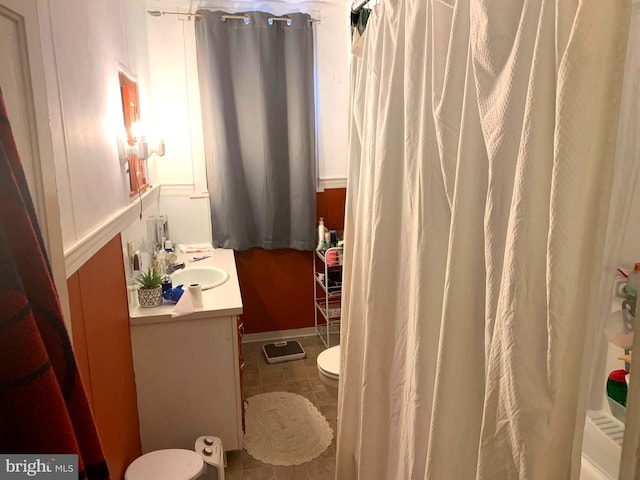 bathroom with tile patterned flooring, vanity, and toilet