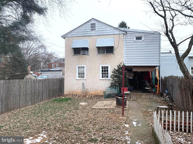 back of property with a patio area