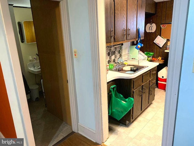 kitchen with sink, backsplash, and dark brown cabinetry