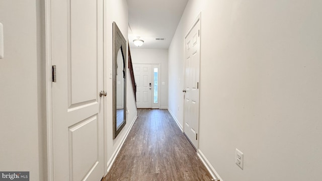 hallway with dark wood-type flooring