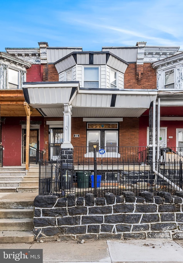 townhome / multi-family property with covered porch