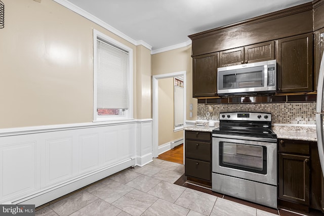 kitchen featuring dark brown cabinetry, ornamental molding, appliances with stainless steel finishes, and a baseboard heating unit