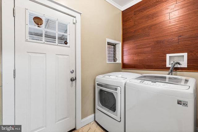 washroom with washer and dryer and ornamental molding