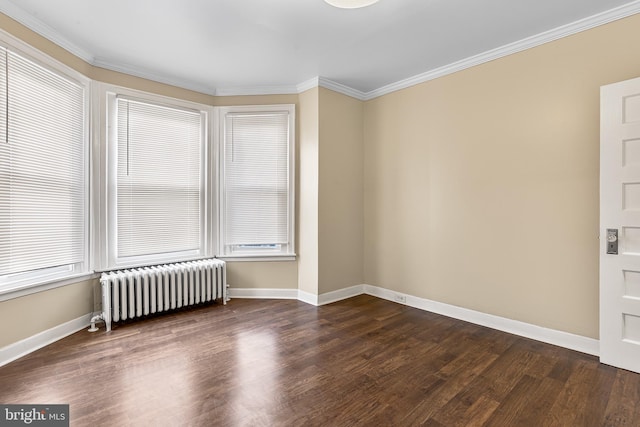 spare room featuring radiator, dark wood-type flooring, and ornamental molding