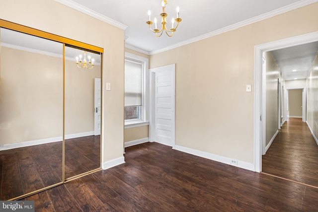 interior space featuring dark hardwood / wood-style flooring, an inviting chandelier, a closet, and crown molding