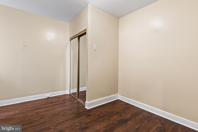 unfurnished bedroom with wood-type flooring and a closet