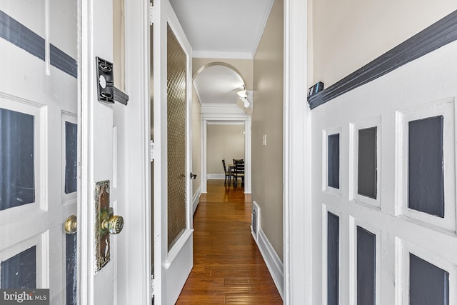 hall featuring dark hardwood / wood-style floors and crown molding