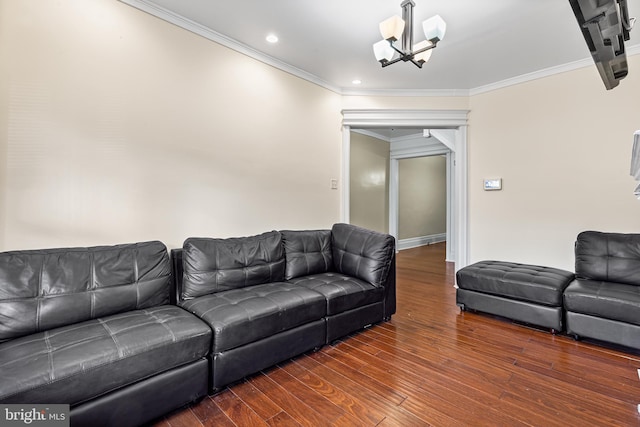 living room featuring dark hardwood / wood-style floors, crown molding, and a notable chandelier