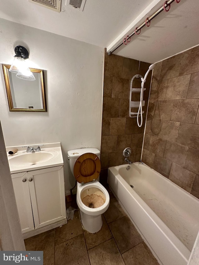 full bathroom with vanity, toilet, and tiled shower / bath