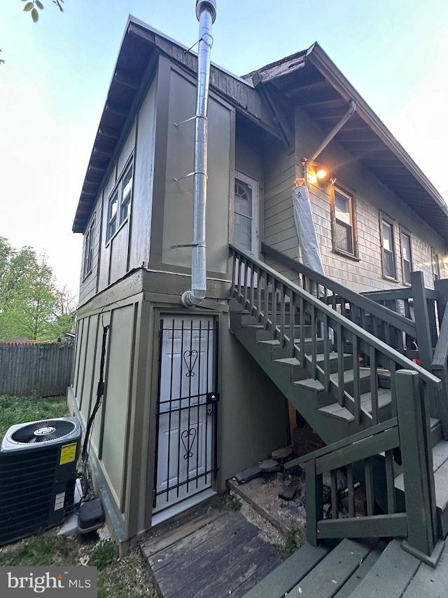 view of side of property featuring central AC