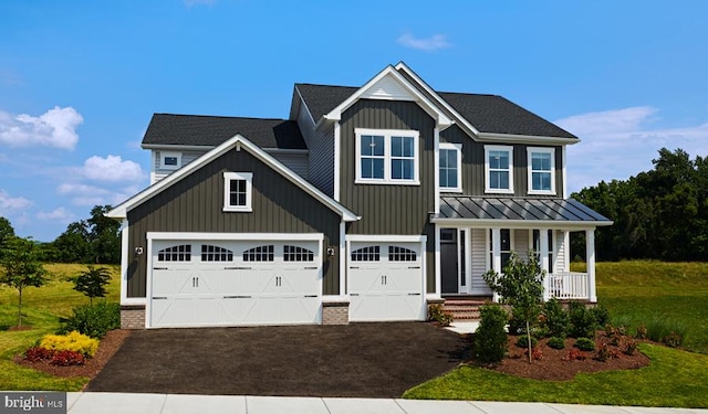 craftsman inspired home with covered porch and a garage