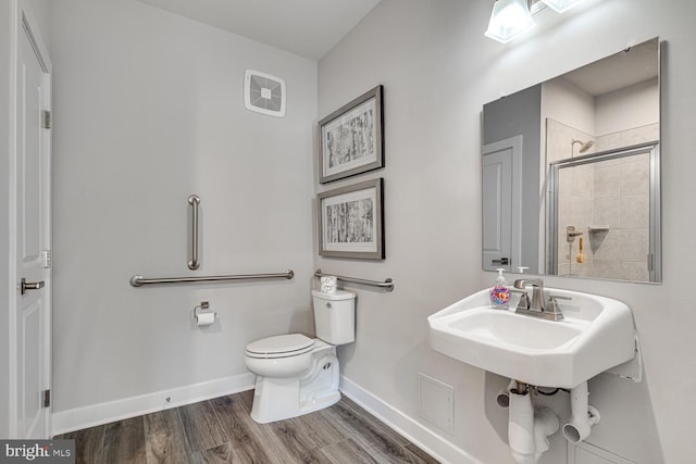 bathroom featuring hardwood / wood-style flooring, toilet, and walk in shower