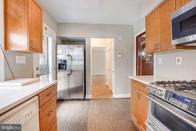 kitchen with dark wood-type flooring and appliances with stainless steel finishes