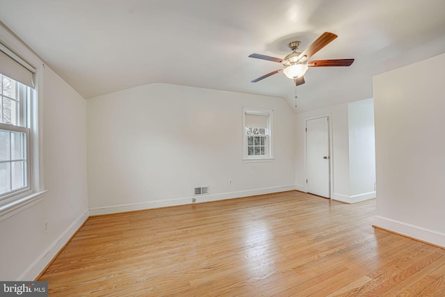 spare room featuring ceiling fan, light hardwood / wood-style floors, and lofted ceiling