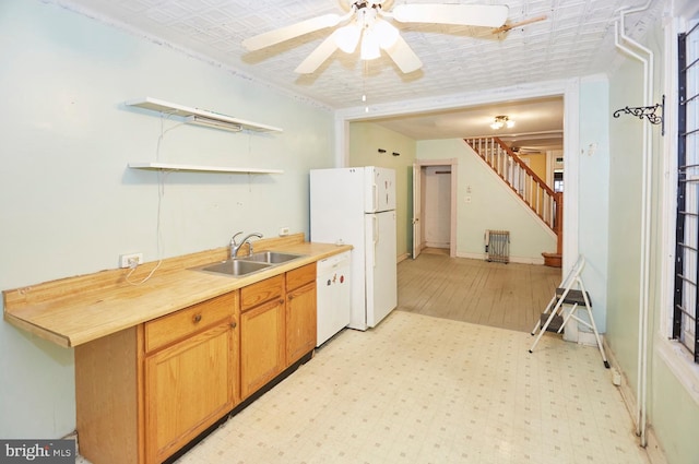 kitchen featuring white appliances, ceiling fan, and sink