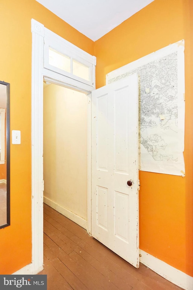 hallway with wood-type flooring