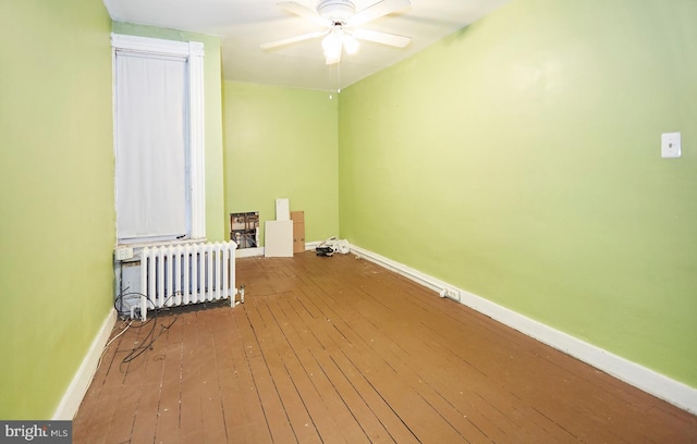 washroom with radiator, ceiling fan, and hardwood / wood-style flooring