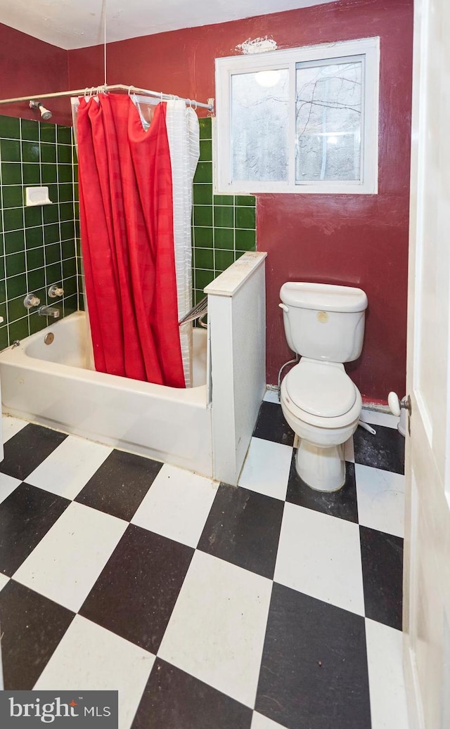 bathroom featuring shower / bath combination with curtain and toilet