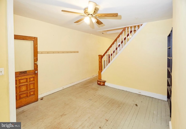 interior space with ceiling fan and wood-type flooring