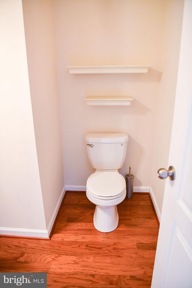 bathroom with wood-type flooring and toilet