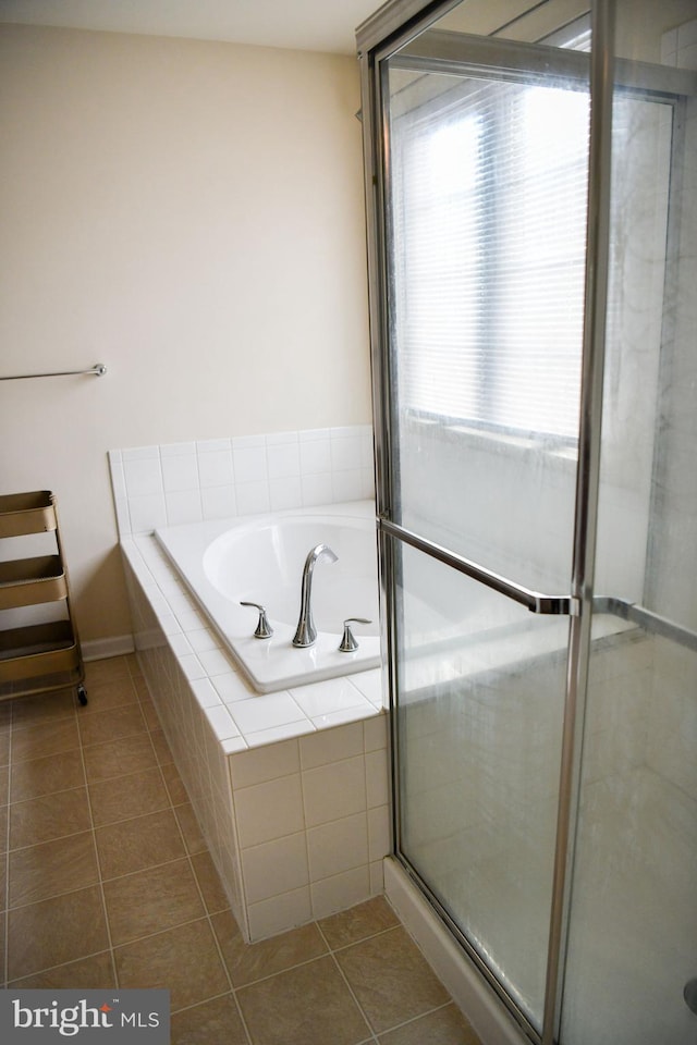 bathroom featuring tile patterned floors and independent shower and bath