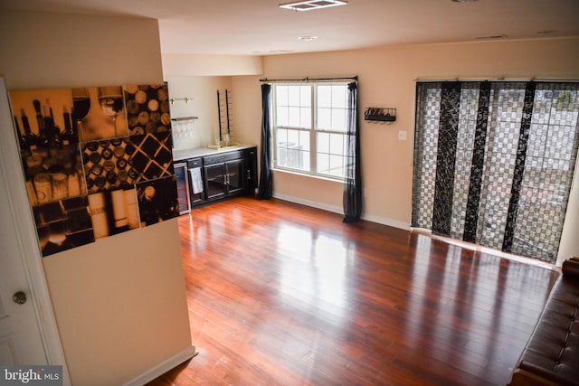 interior space featuring wood-type flooring and bar