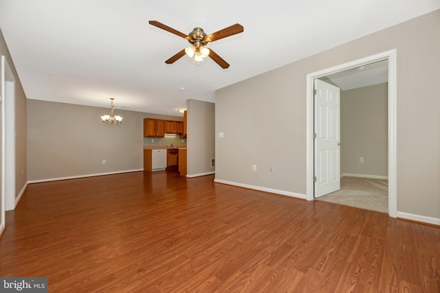 unfurnished living room featuring hardwood / wood-style floors and ceiling fan with notable chandelier