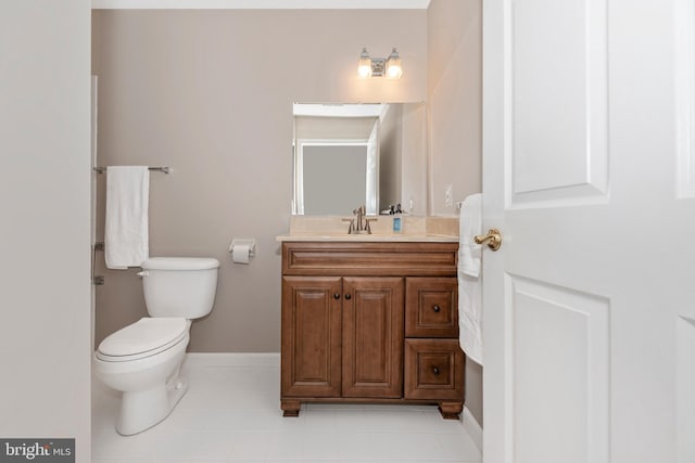 bathroom featuring tile patterned flooring, vanity, and toilet