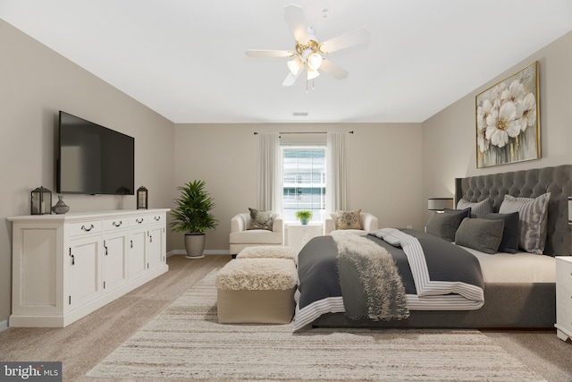 bedroom featuring light colored carpet and ceiling fan