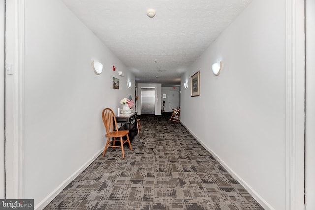 corridor featuring a textured ceiling