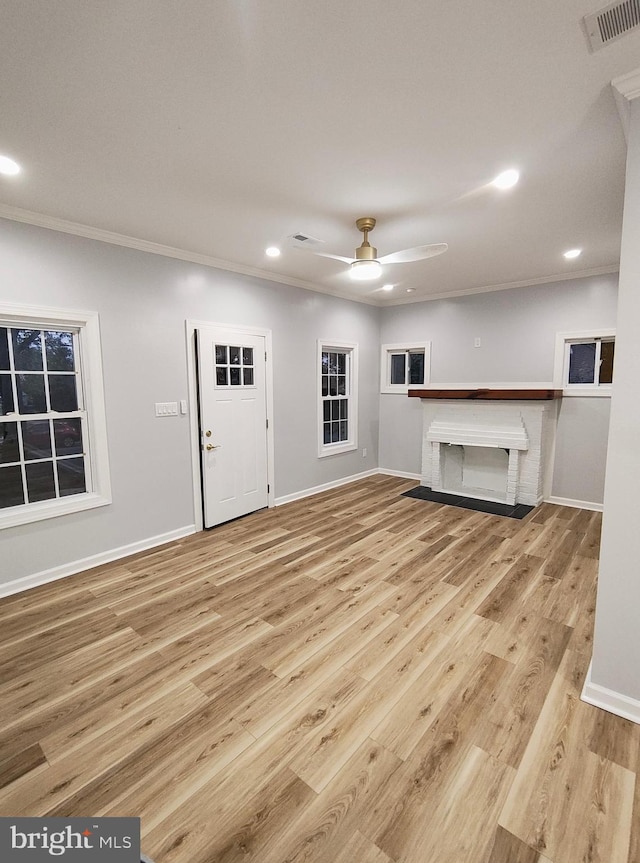 unfurnished living room with ceiling fan, light hardwood / wood-style floors, and crown molding